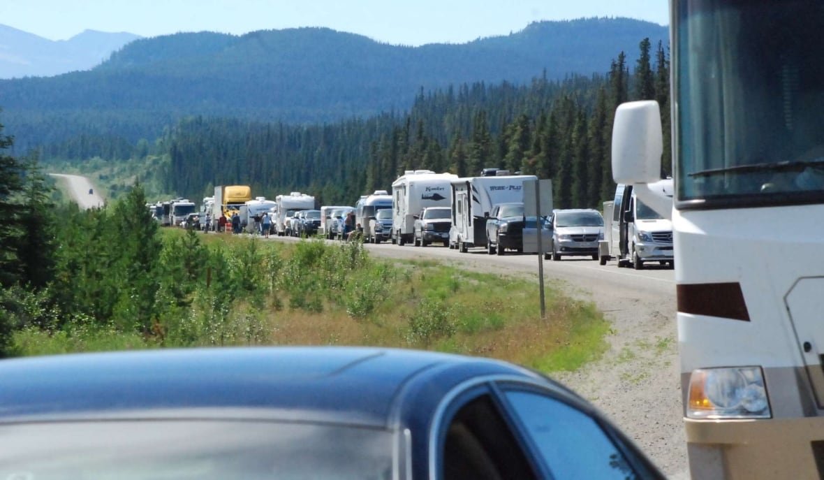 Traffic along a highway through a forested landscape.
