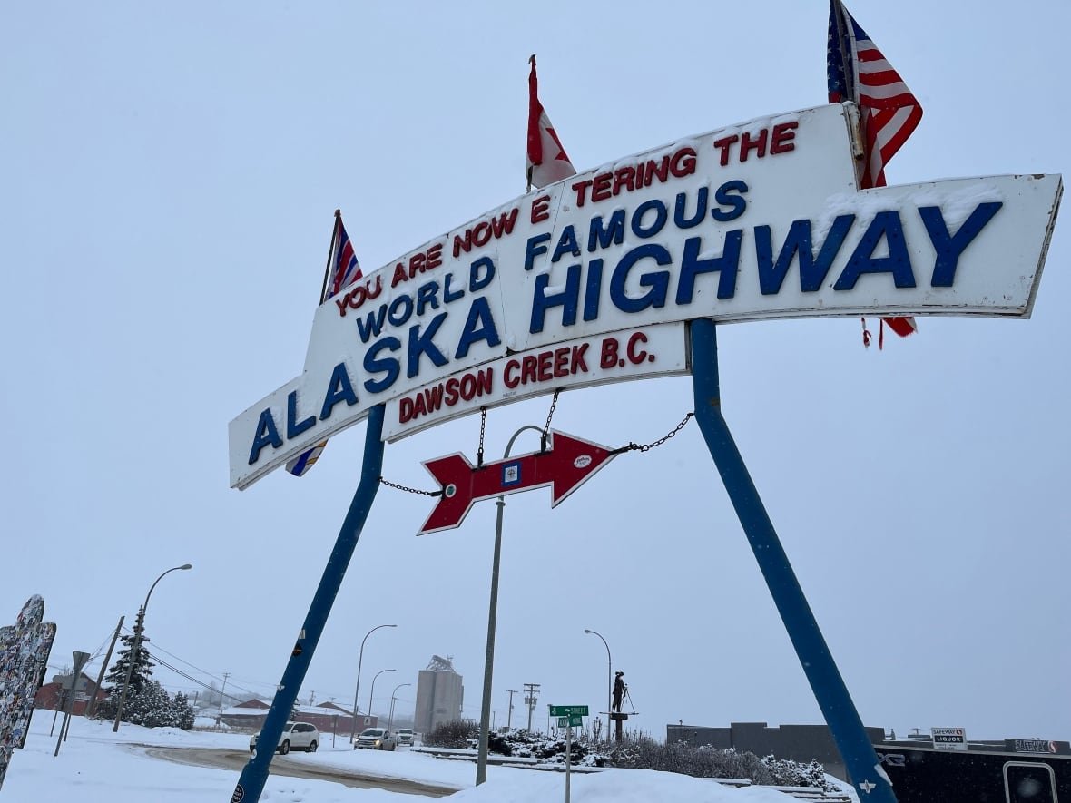 A large sign reading 'You're now entering the world famous Alaska Highway.'