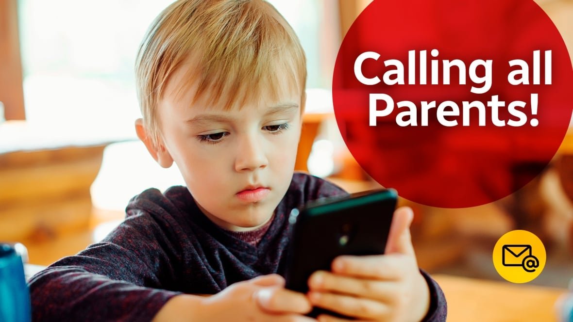 A kid looks down at a phone.
