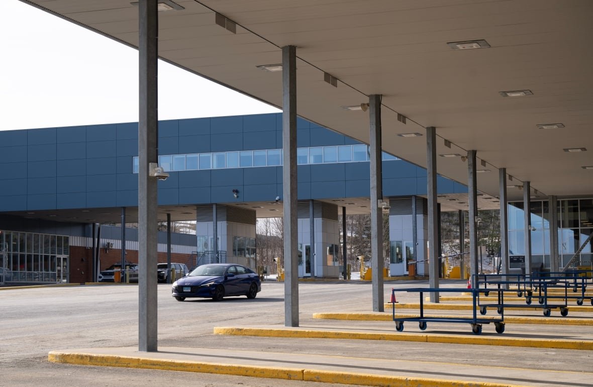 cda-border-20250313-1 A car drives past inspection bays as it enters Canada from Vermont at the Highway 55 Port of Entry in Stanstead, Que., Thursday, March 13, 2025.