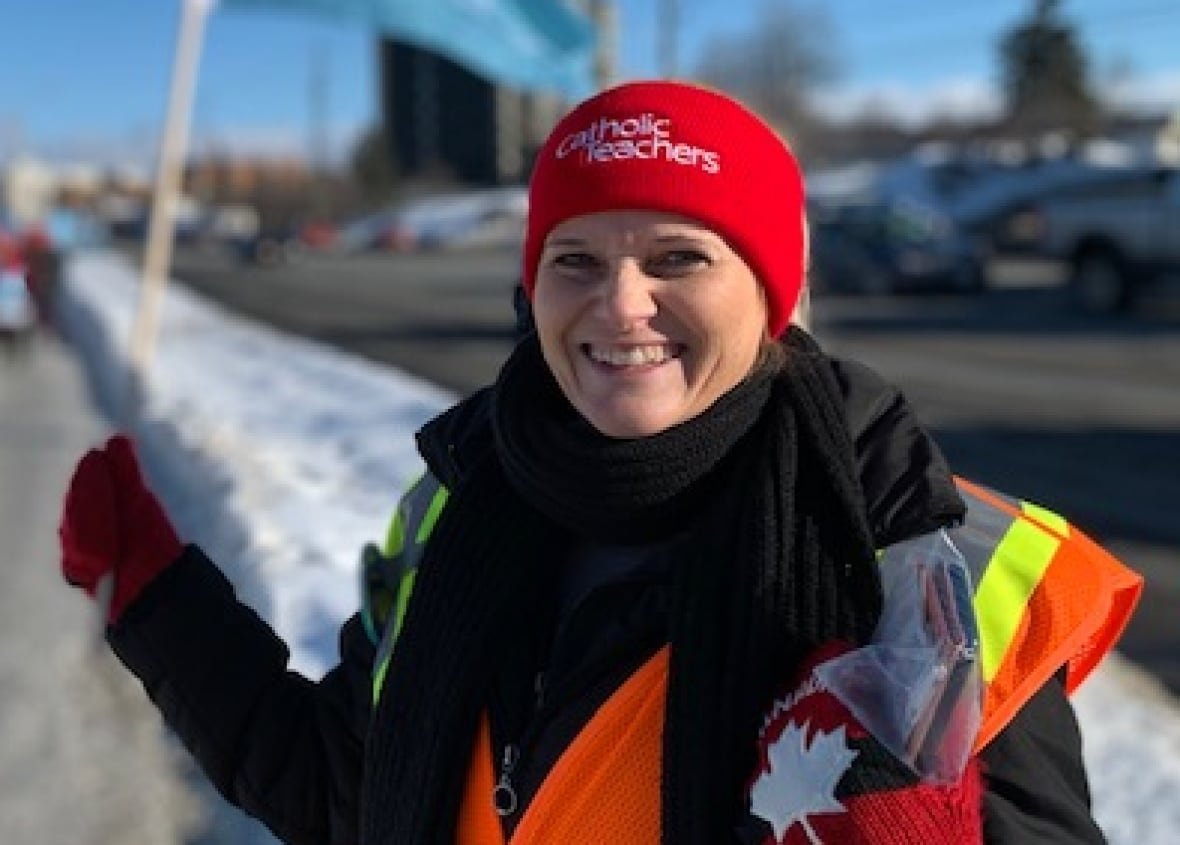 A smiling woman wearing a red hat.