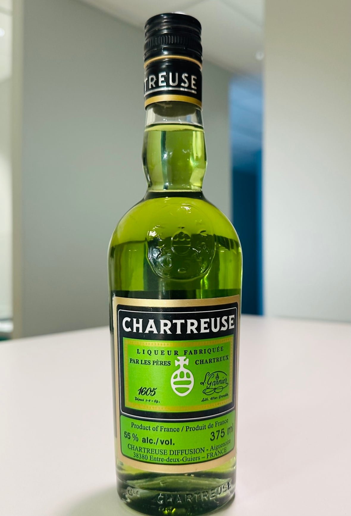chartreuse A bottle of liqueur sits on a table