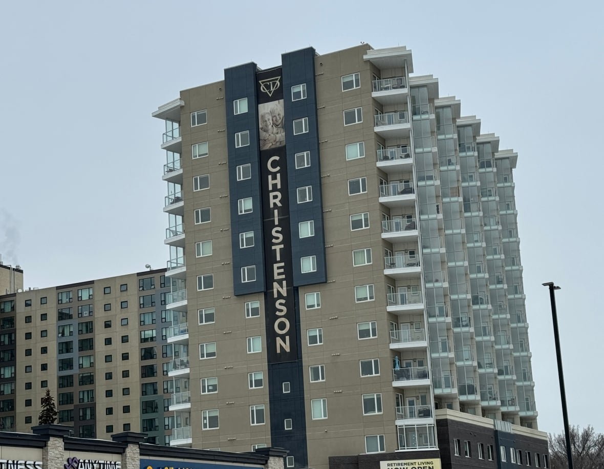 christenson-group A view of a tall apartment building that says "Christenson" down the side.