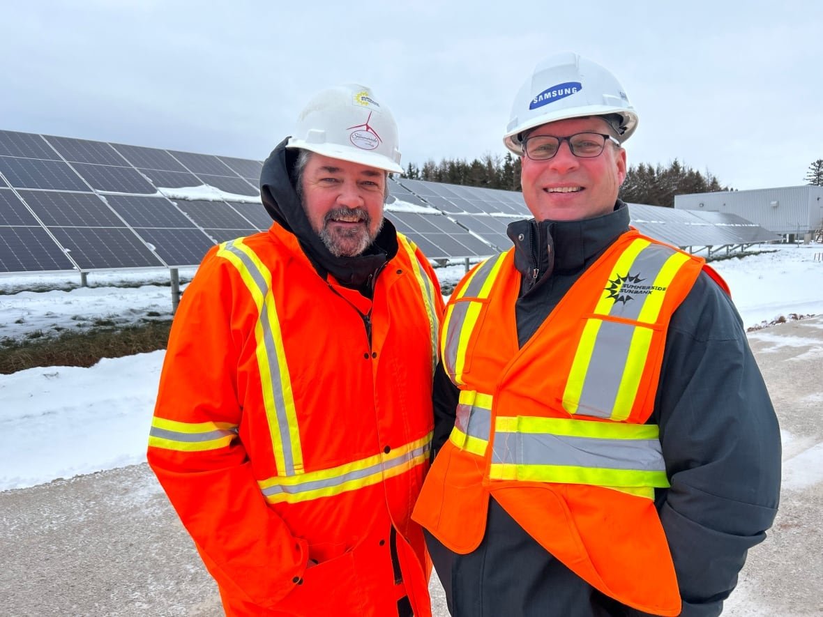 Greg Gaudet director of municipal service and Mike Thususka Director of Economic Development stand by solar panels