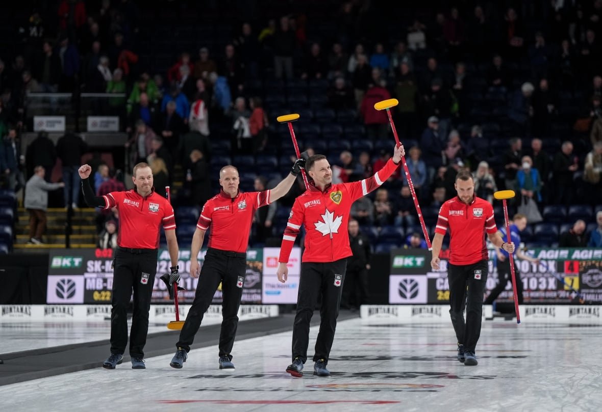 cur-brier-20250307-1 Four curlers celebrate a win.