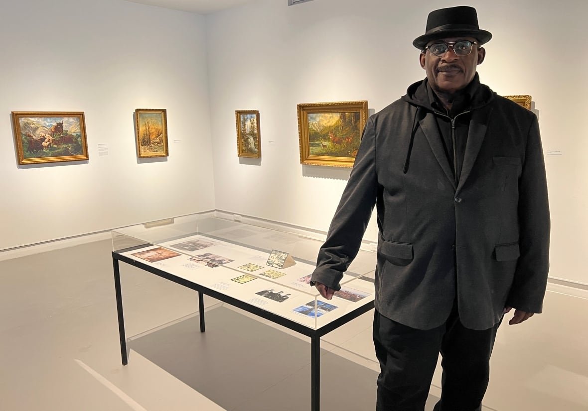 david-woods A Black man is shown inside of an art gallery.