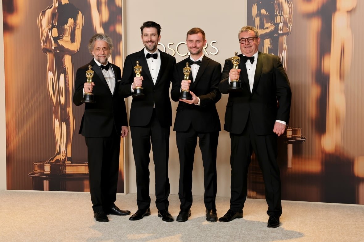dune-part-two Four men pose with awards.