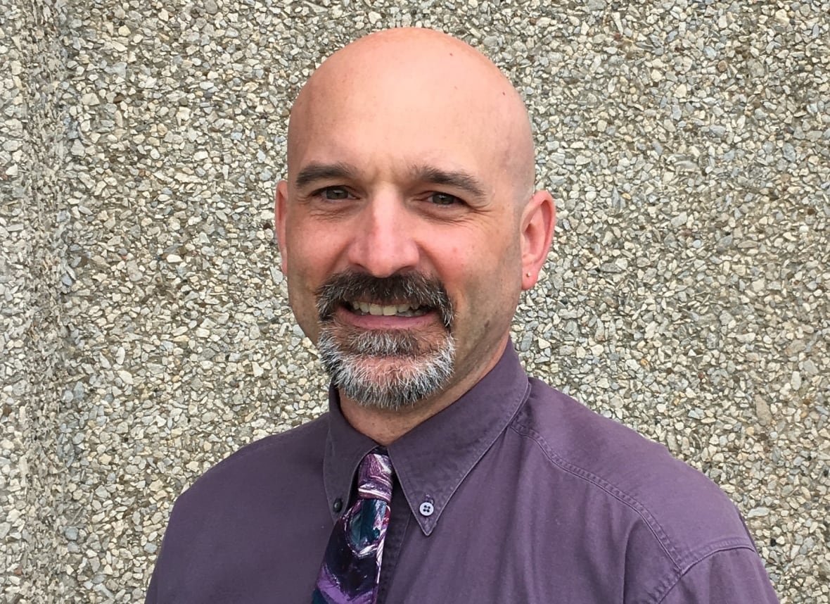 A bald man with a beard.