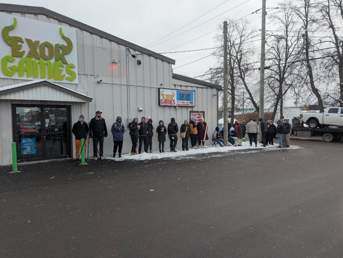 People lined up outside a building in the winter.