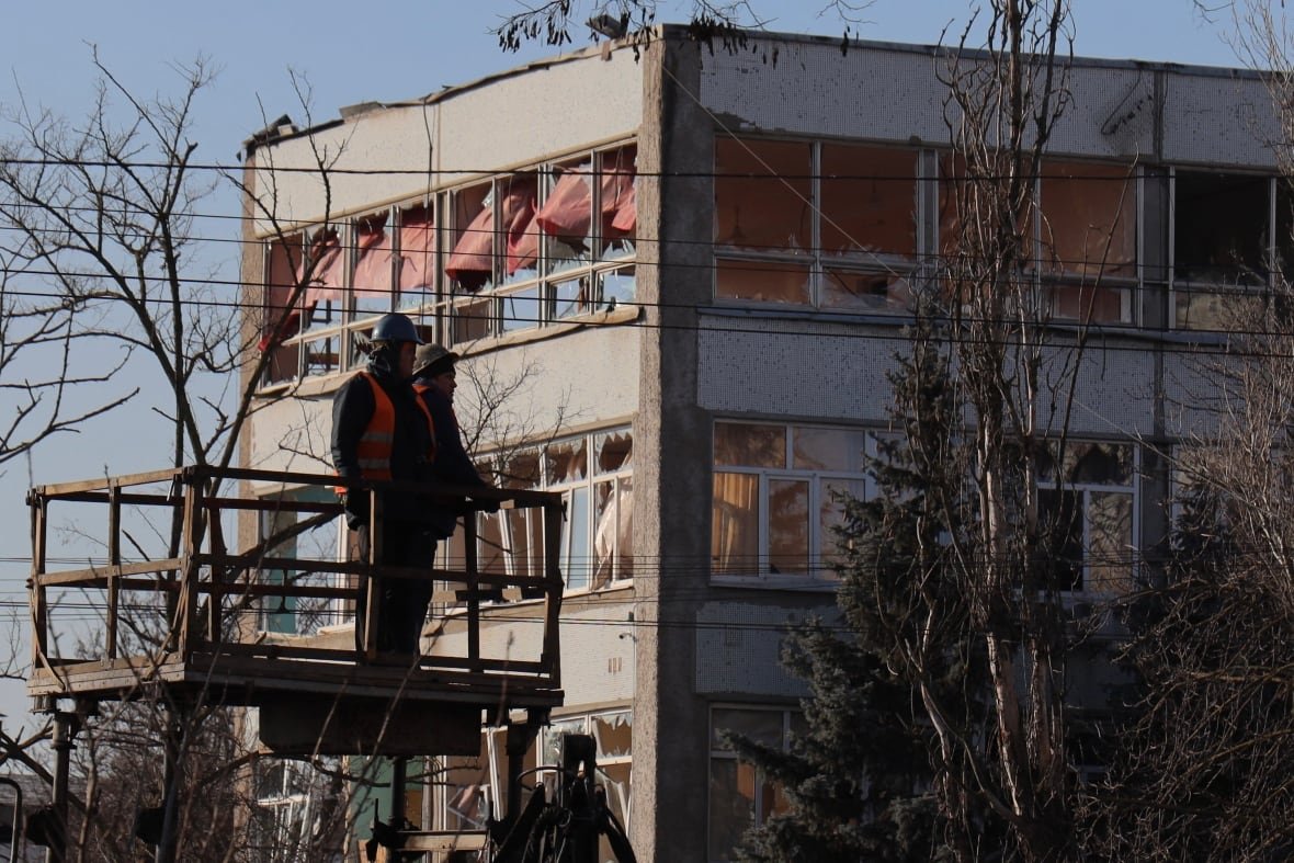 Firefighters look at a damaged hospital in Odesa, Ukraine.
