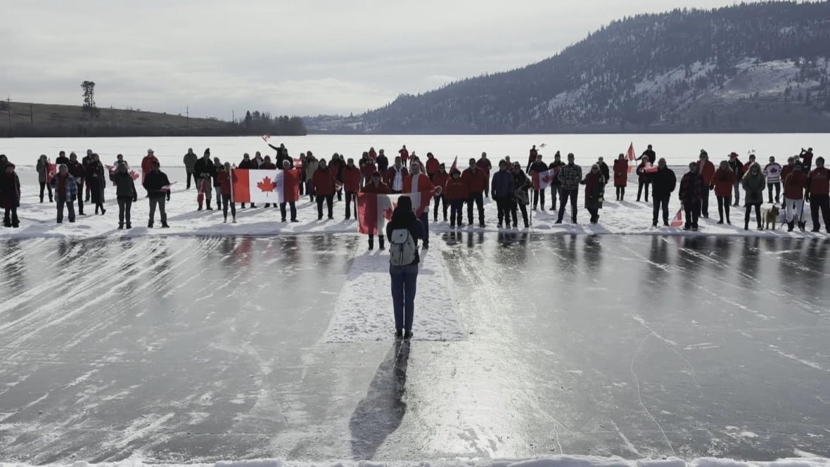 Dozens of people on an icy lake.