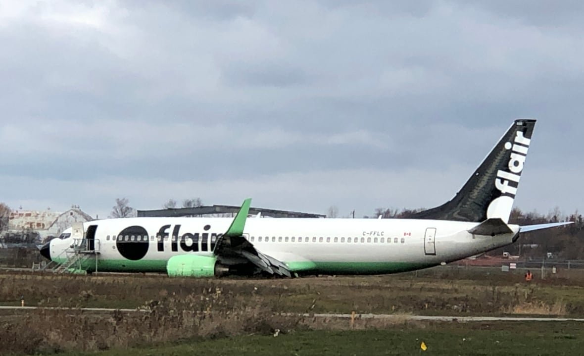 A plane damaged from overrunning a runway.