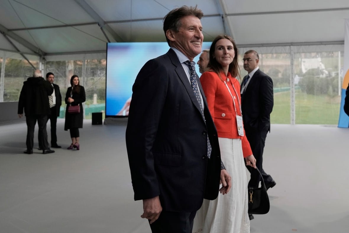 greece-olympics-ioc-election-3 A man smiles as a woman stands beside him.