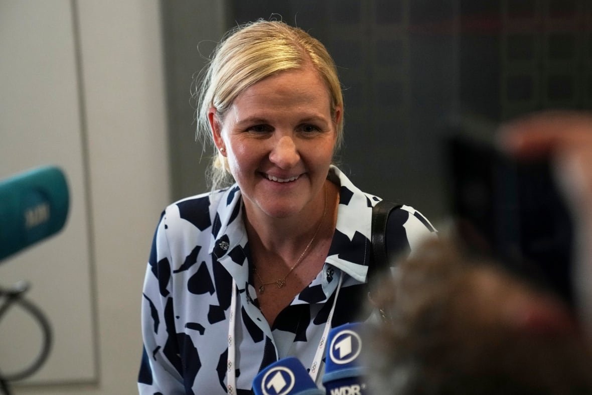 greece-olympics-ioc-election-5 A woman smiles.