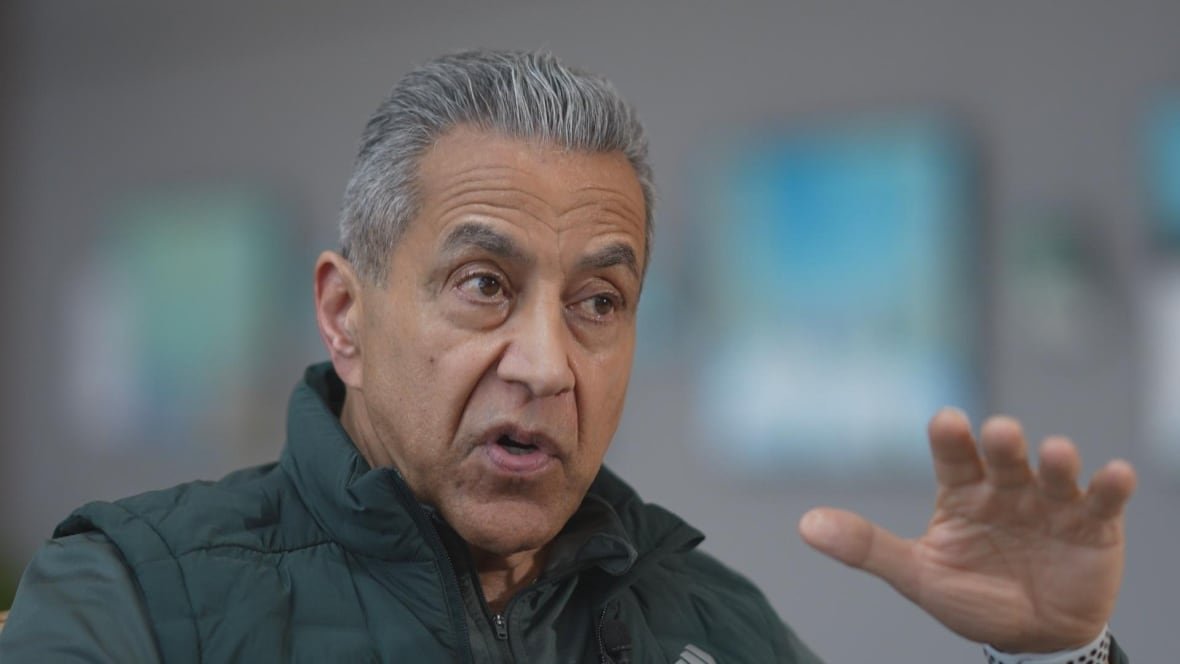 kash-heed A South Asian man with white hair is seen gesturing as he speaks.