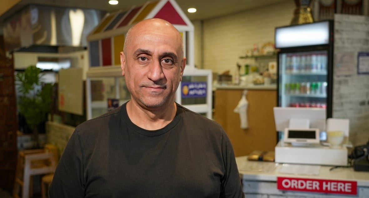 A bald man poses for a photo.