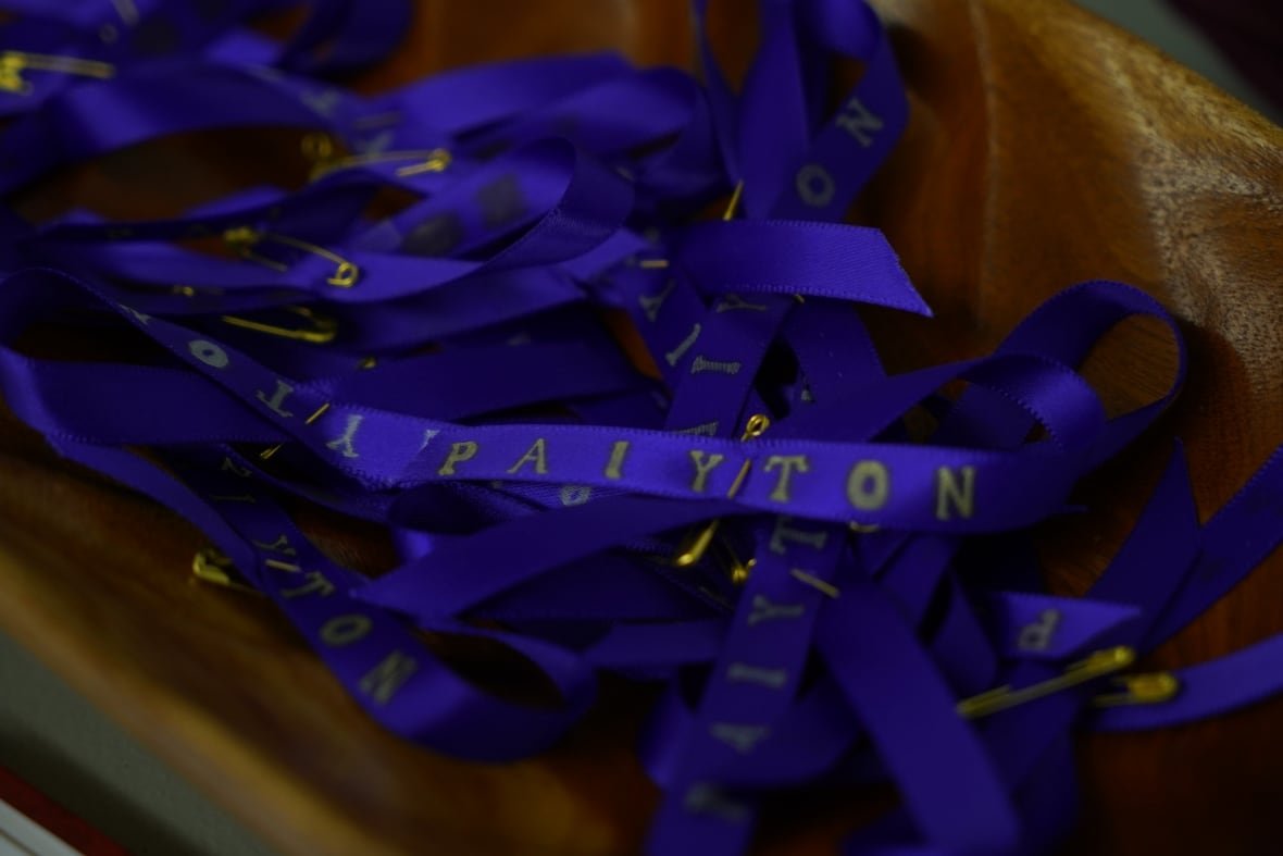 memory-ribbons-for-paiyton-pick Purple ribbons that say "Paiyton" on them in a wooden bowl are shown