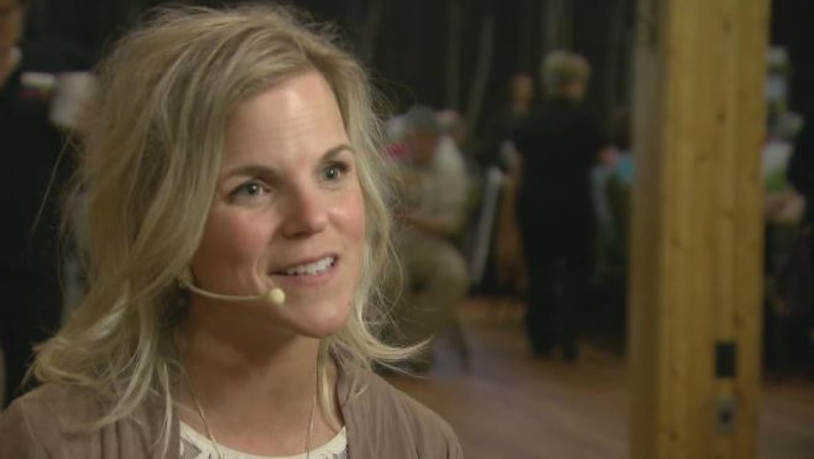 Woman speaking to a reporter