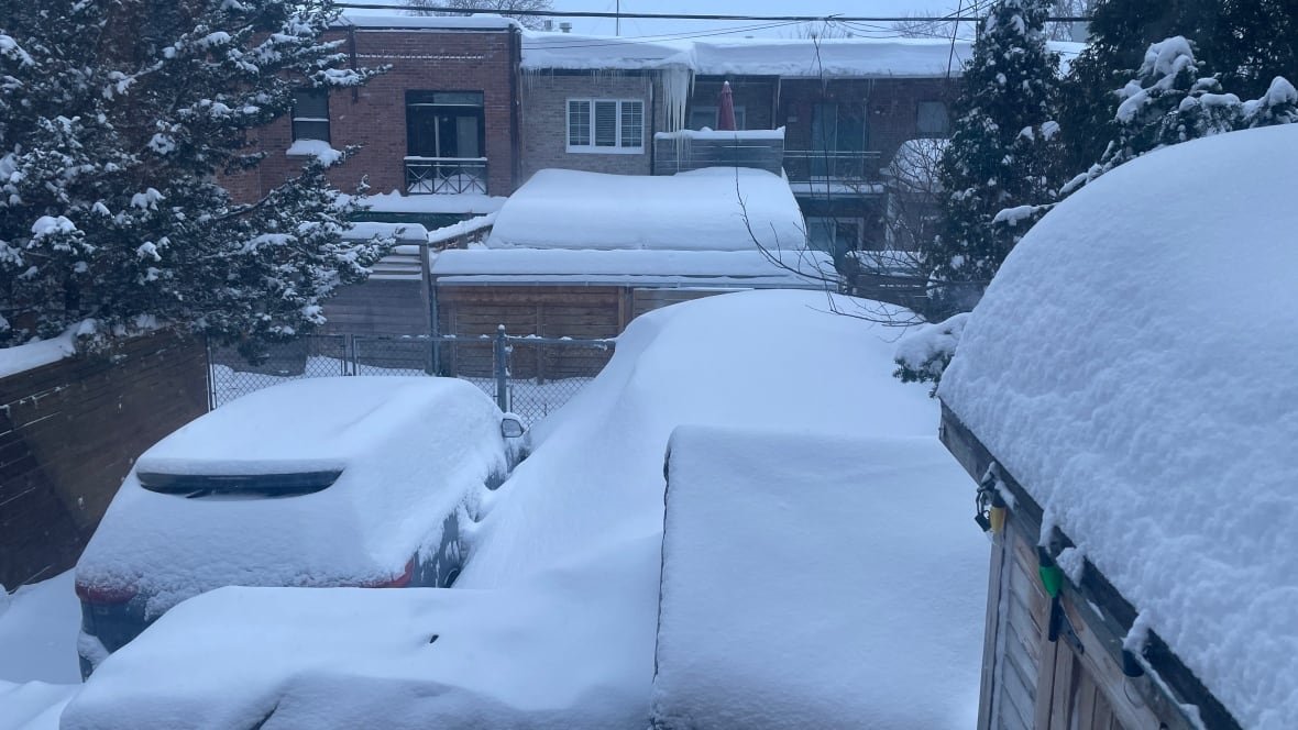 montreal-snow Snow piles up in a backyard.