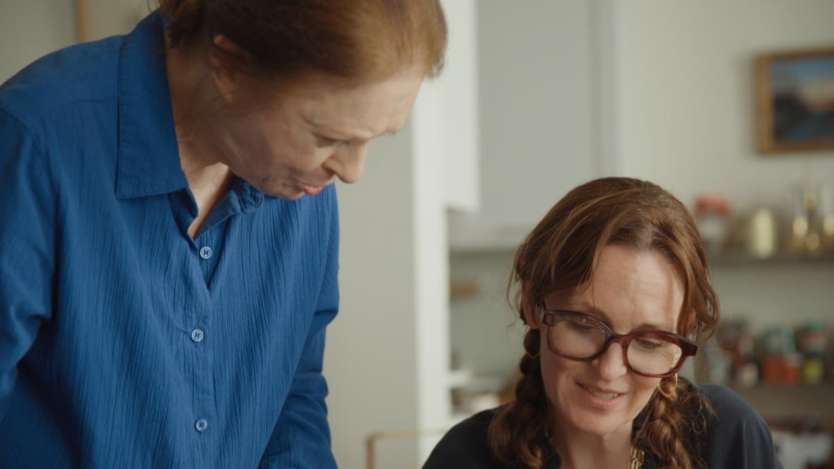 Two women with long red hair, one older than the other.