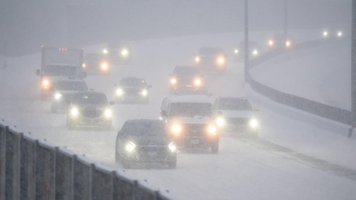 Cars driving in near whiteout conditions