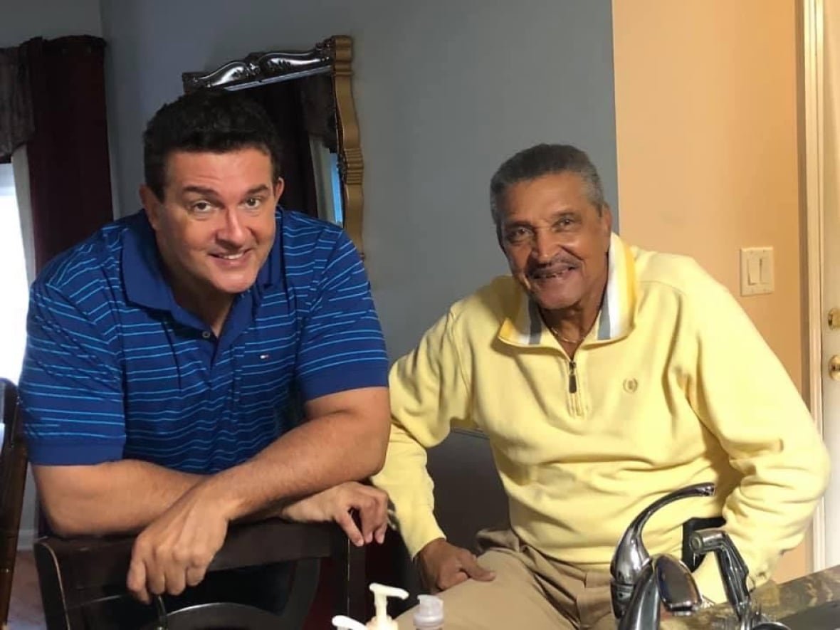 paul-hodgson-with-birth-father-jerry-arceneaux A middle age man, left, sitting next to an older man, right.