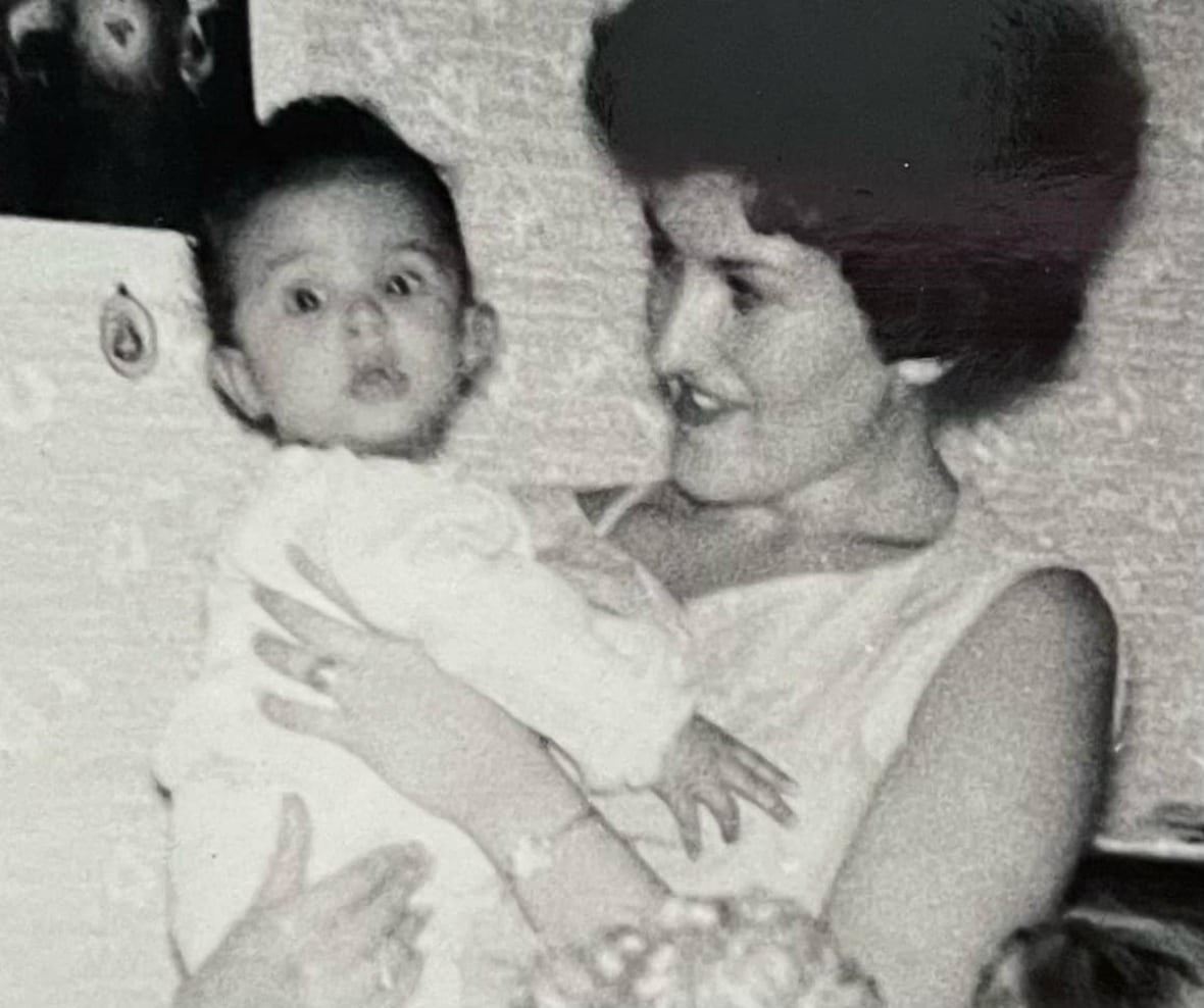 paul-hodgson-with-birth-mother-elaine A black and white photo of a young lady holding a baby in her arms