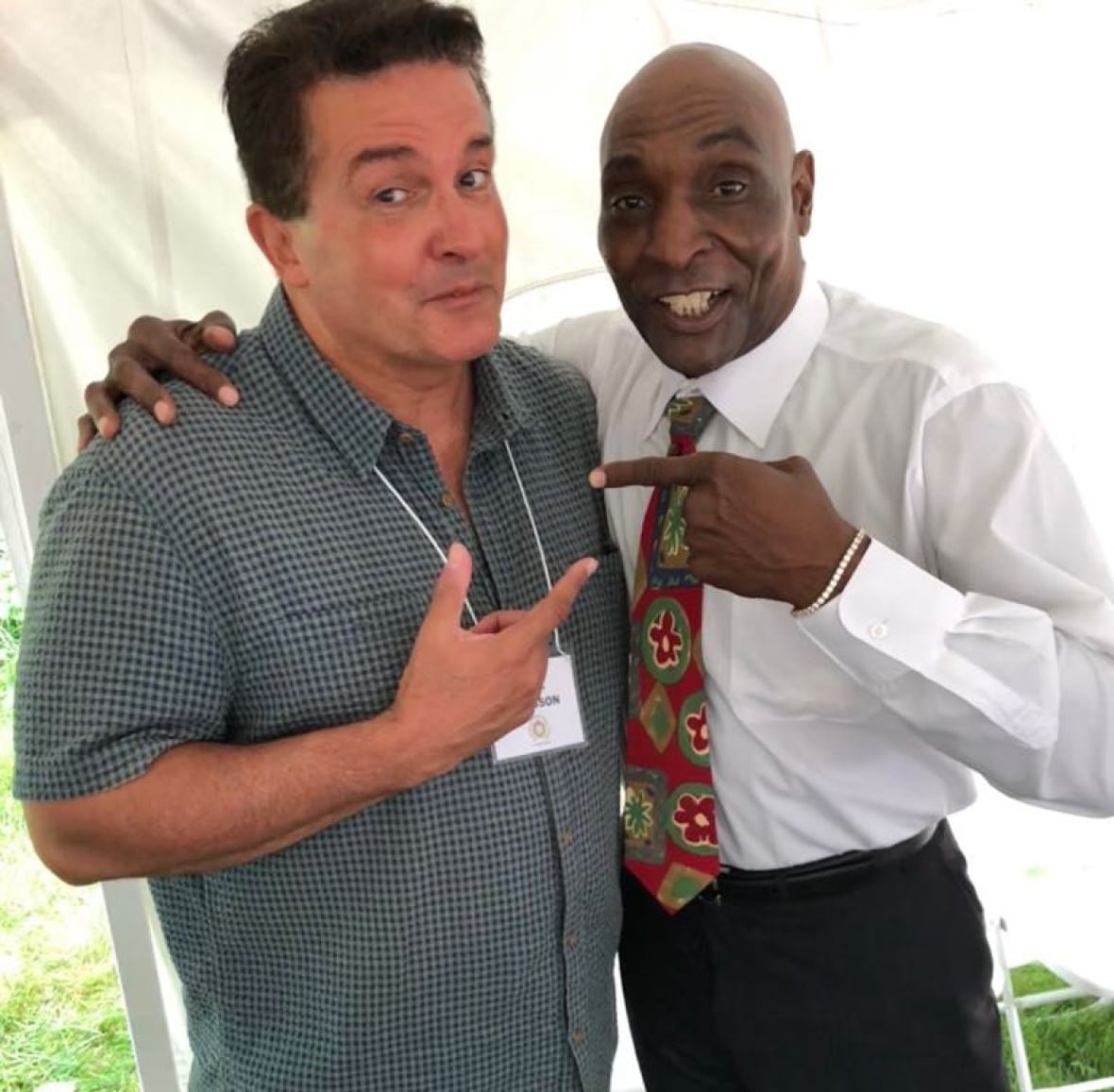paul-hodgson-with-lloyd-moseby Two men standing side-by-side and pointing at each other