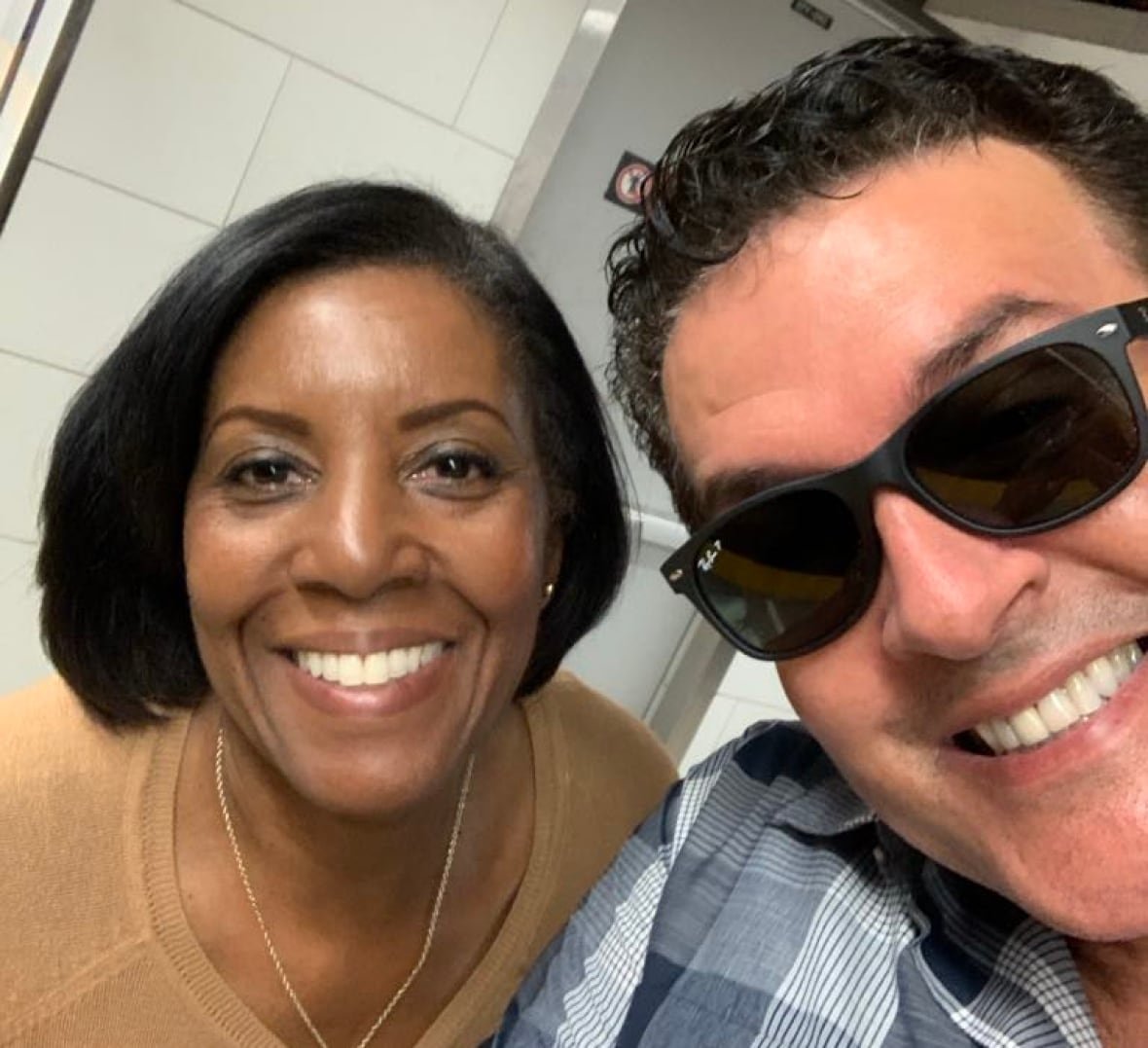paul-hodgson-with-sister A selfie of a smiling woman, left, and a smiling man wearing sunglasses, right