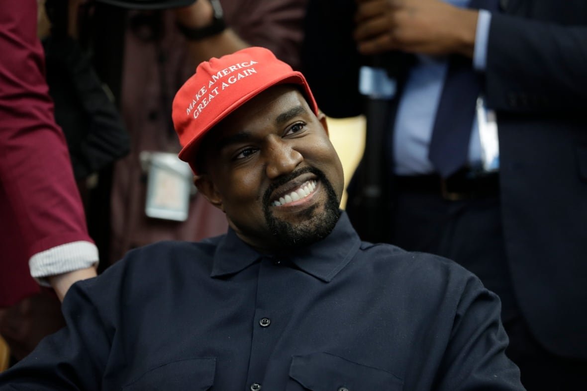 Rapper Kanye West wears a Make America Great again hat during a meeting with President Donald Trump in the Oval Office of the White House on Oct. 11, 2018. West issued a cryptic answer by text to a reporter about his electoral ambitions, but Democrats see Republican influence behind the scenes.