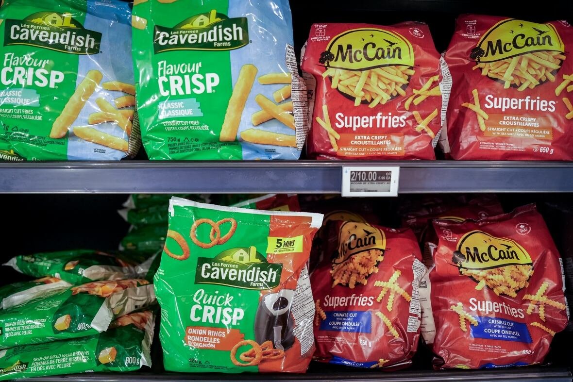 Cavendish and McCain branded potato products are pictured in green and red bags on the shelf at a grocery store.