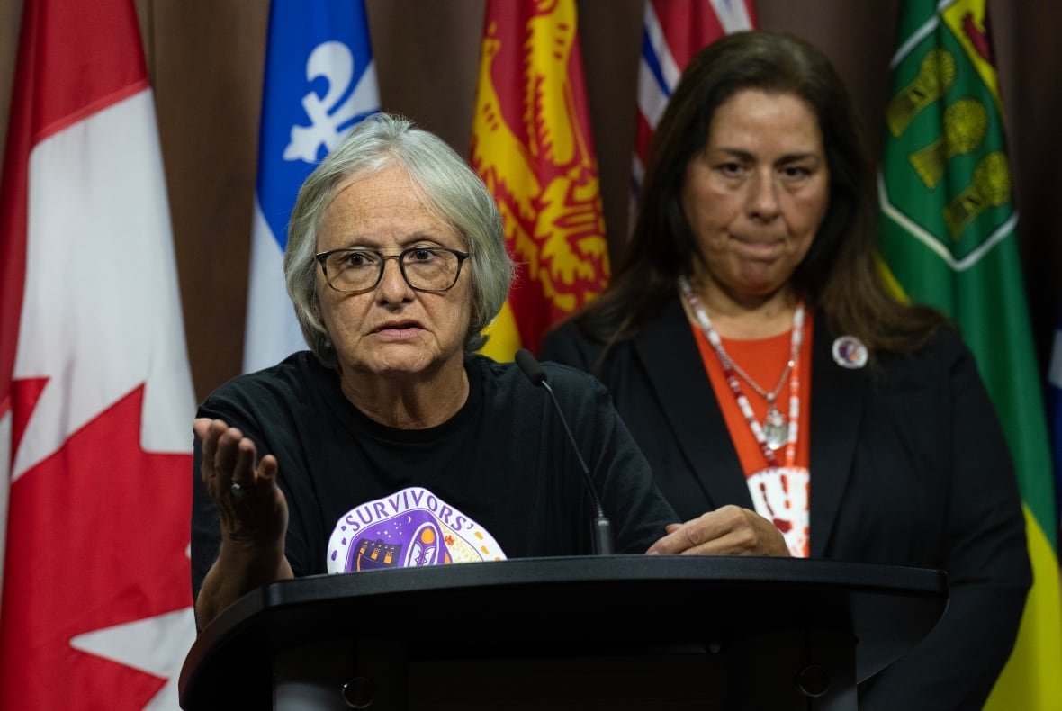 residential-school-funding-20240930 The Survivors’ Secretariat Executive Lead Laura Arndt, right, looks on as Mohawk Institute survivor and Secretariat board member Roberta Hill speaks during a news conference on Parliament Hill, in Ottawa, Monday, Sept. 30, 2024.