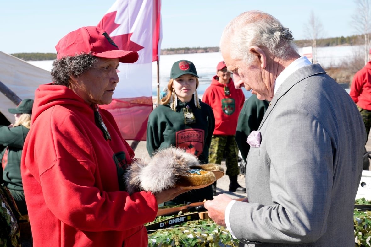 royal-visit-20220519 A person in presented with a pair of moccasins by another person