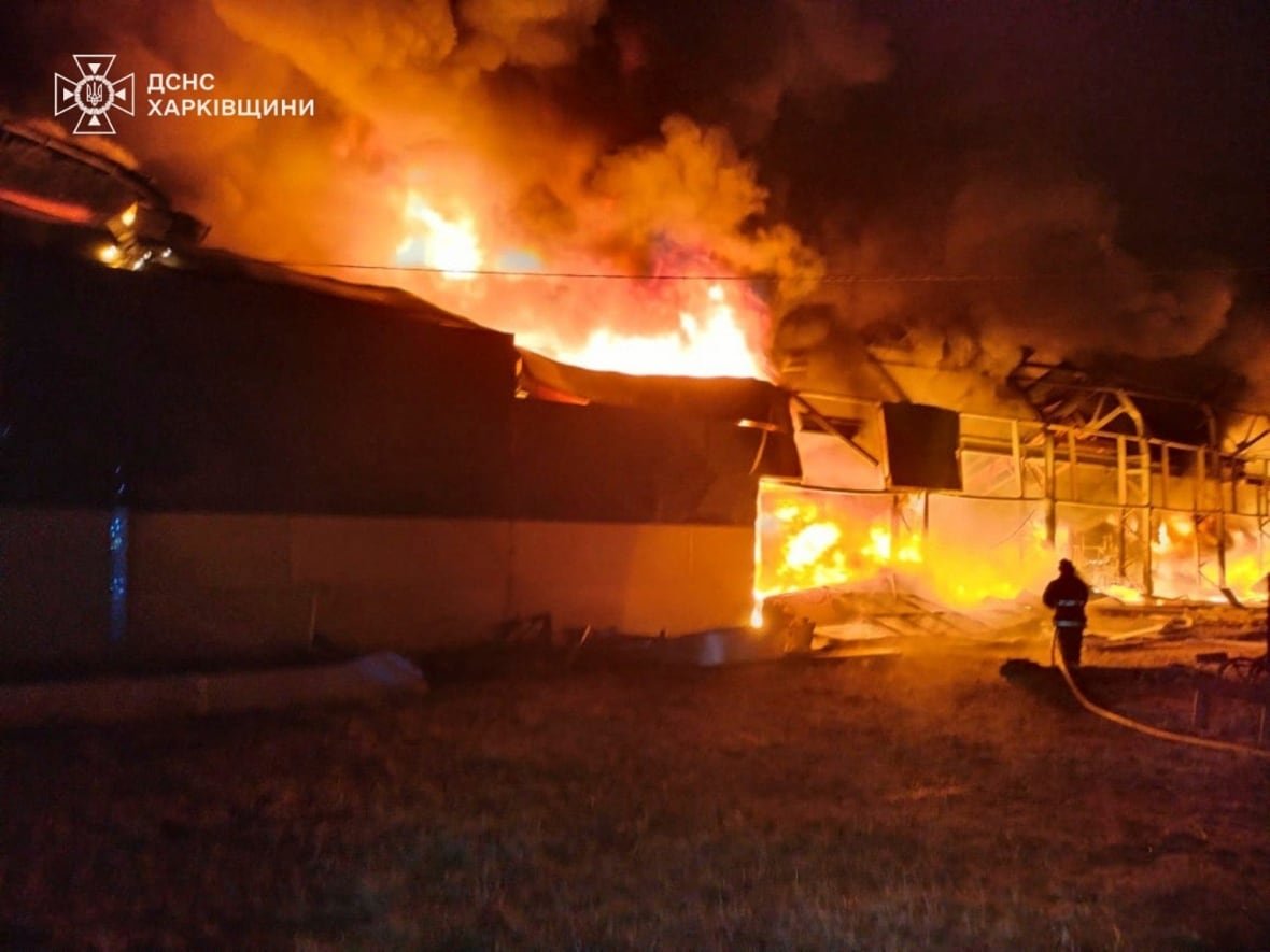 russia-ukraine-war-5 A nighttime scene is lit up orange by an apparent fire.