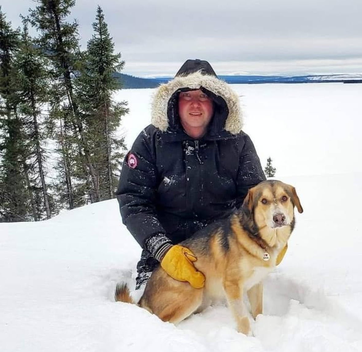 Man and dog with a snowy background