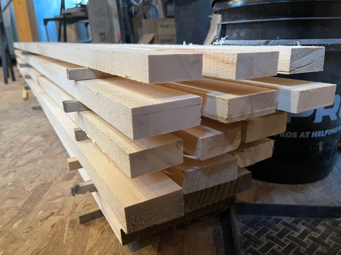 stack-of-locally-sourced-spruce A stack of milled wood in a cabin.