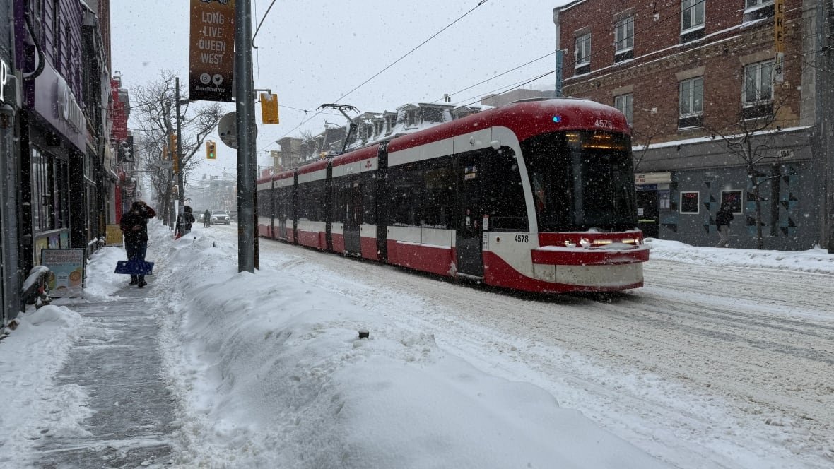 A streetcar travels down a road.