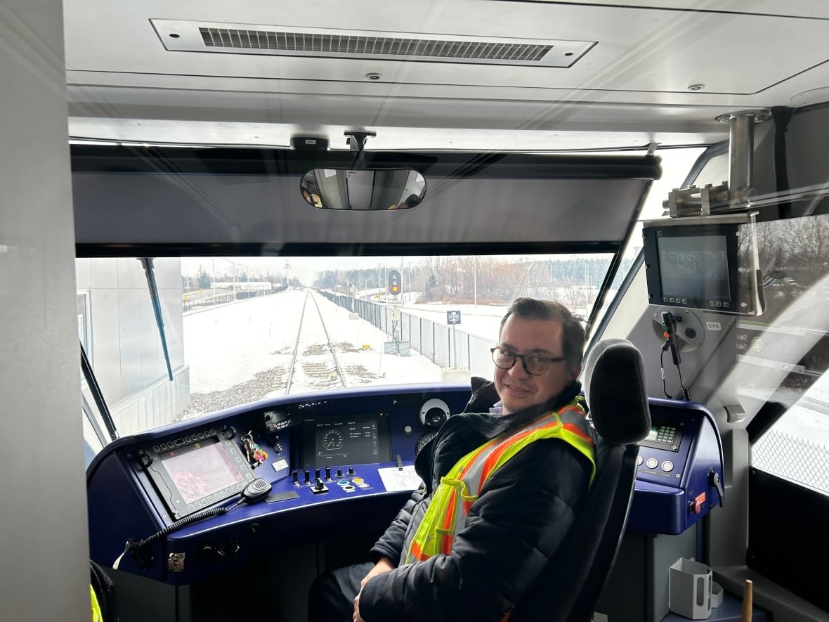 train-operator-oc-transpo-line-4-ottawa-o-train-trillium-line A man sits at the head of an LRT car.