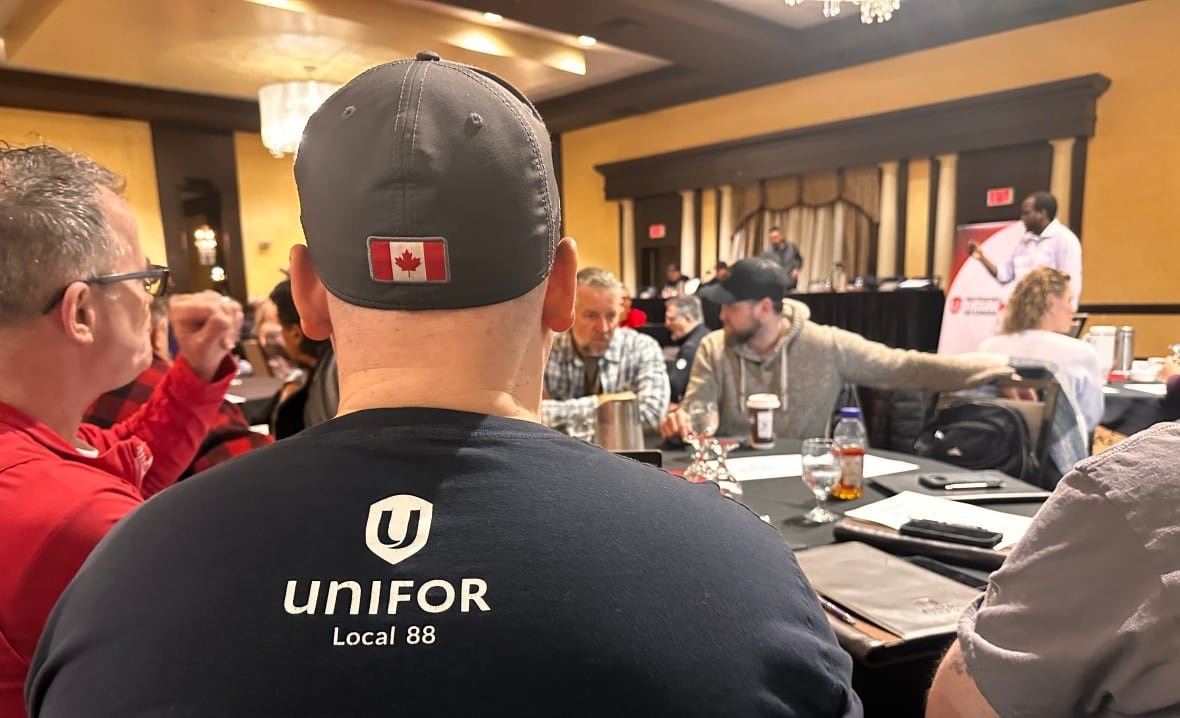 unifor-leaders-meet a group in a room, with unifor on their jackets. it's a meeting of union leaders.