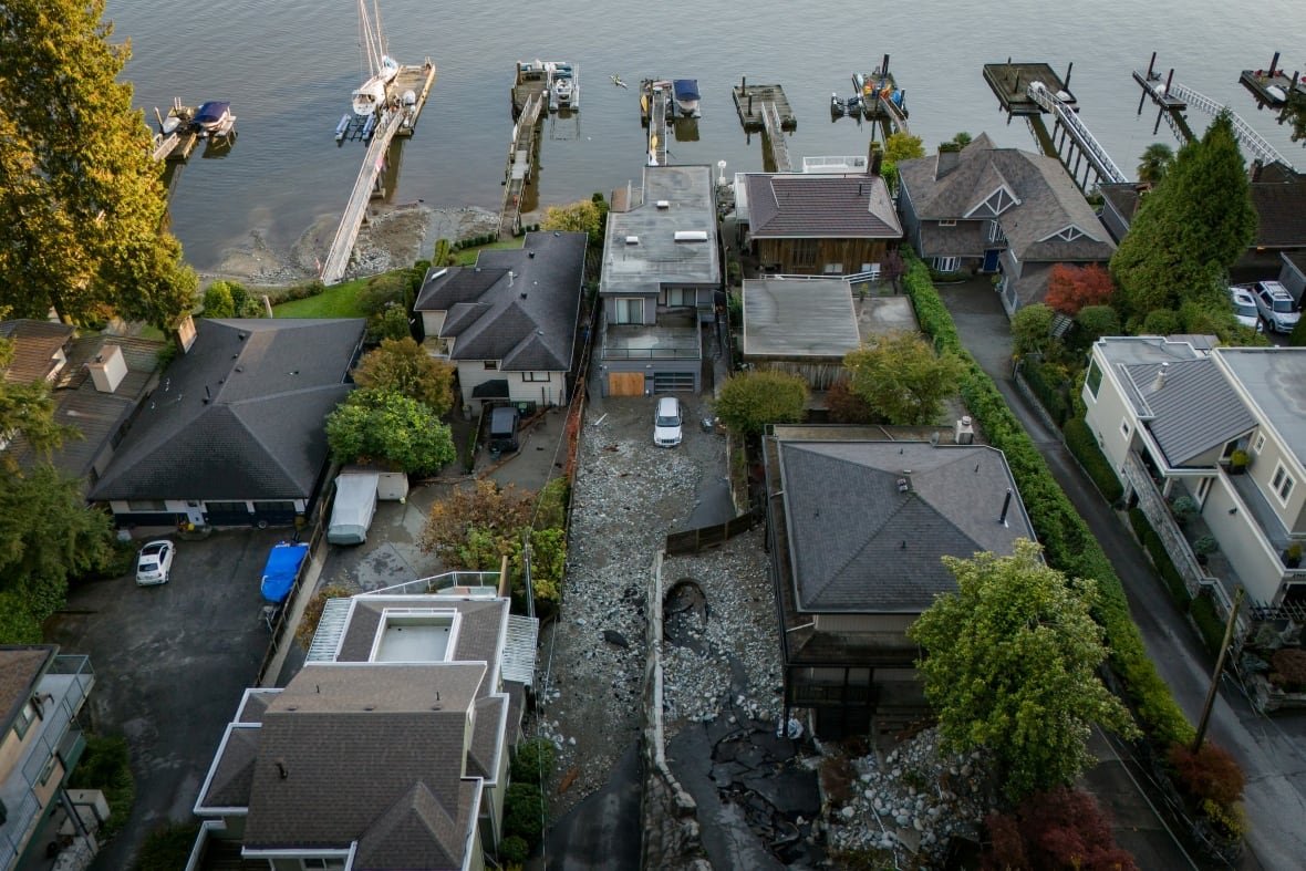 Multiple homes are seen surrounded by debris left by flooding in North Vancouver in October 2024.