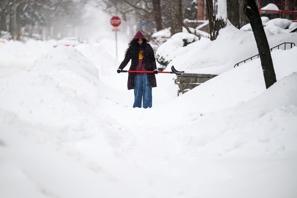 wea-ont-snow-20250216-2 A person shovels snow.