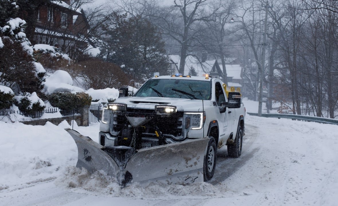 winter-snow-2 Photo of a snowplow clearing a snowy suburban road