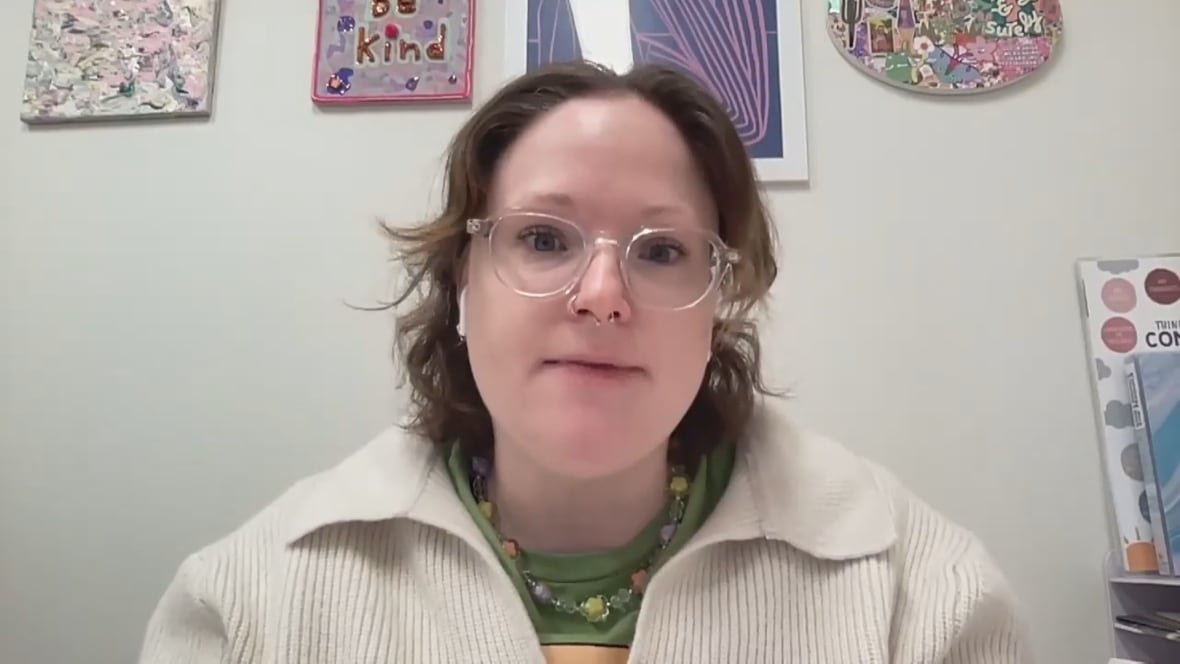 A headshot of a woman wearing glasses.