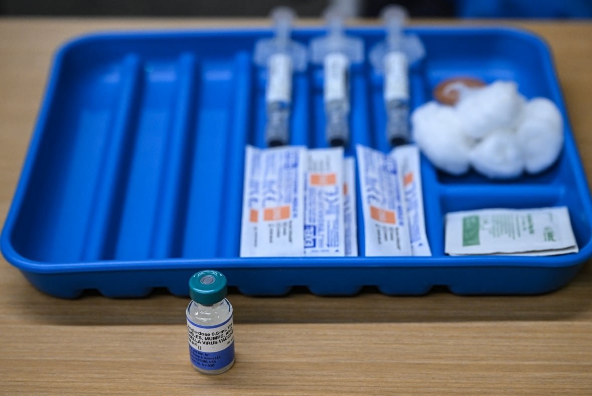 2201750184 A dose of the measles vaccine is seen on a table with vaccination supplies.