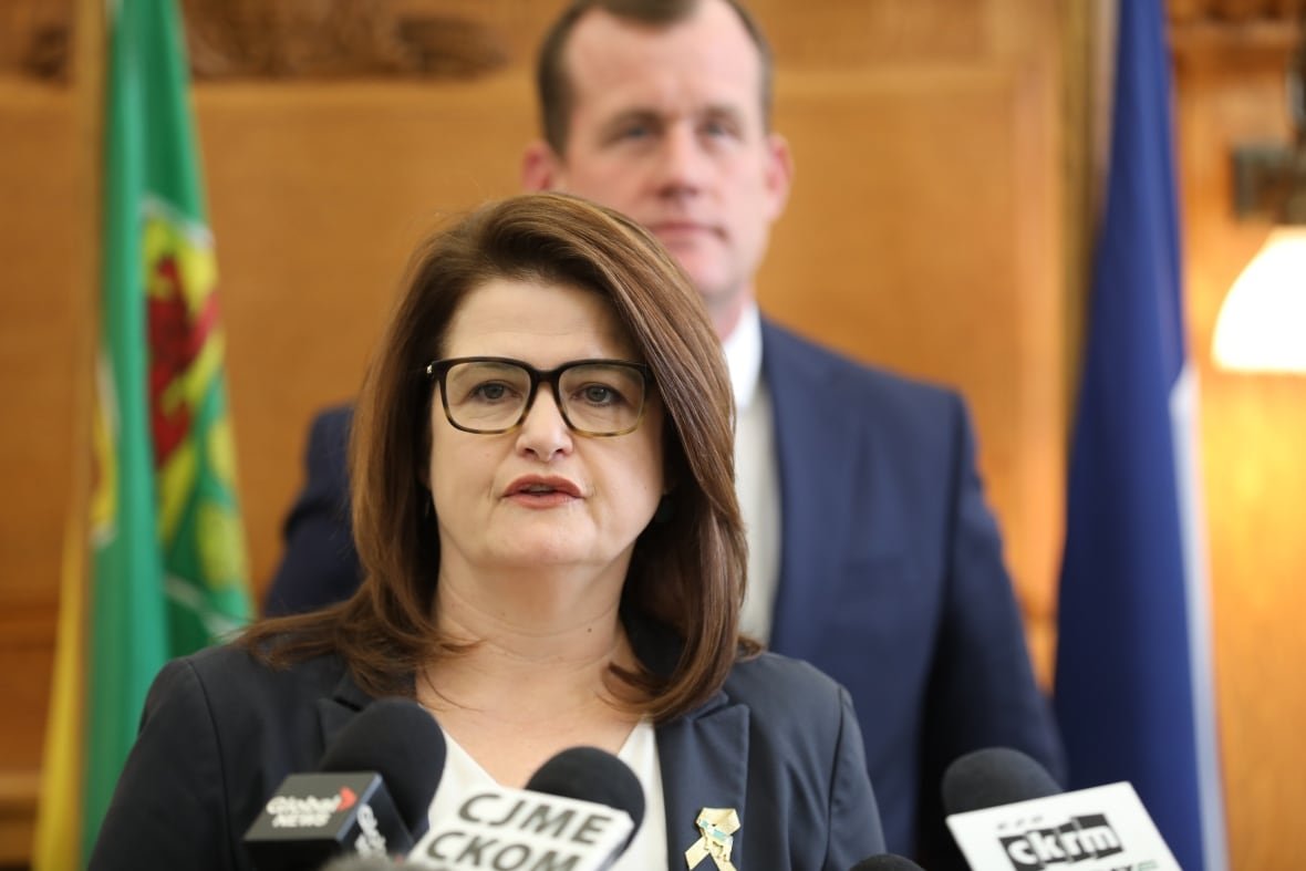 beck-budget-day A woman with glasses speaks into a microphone.