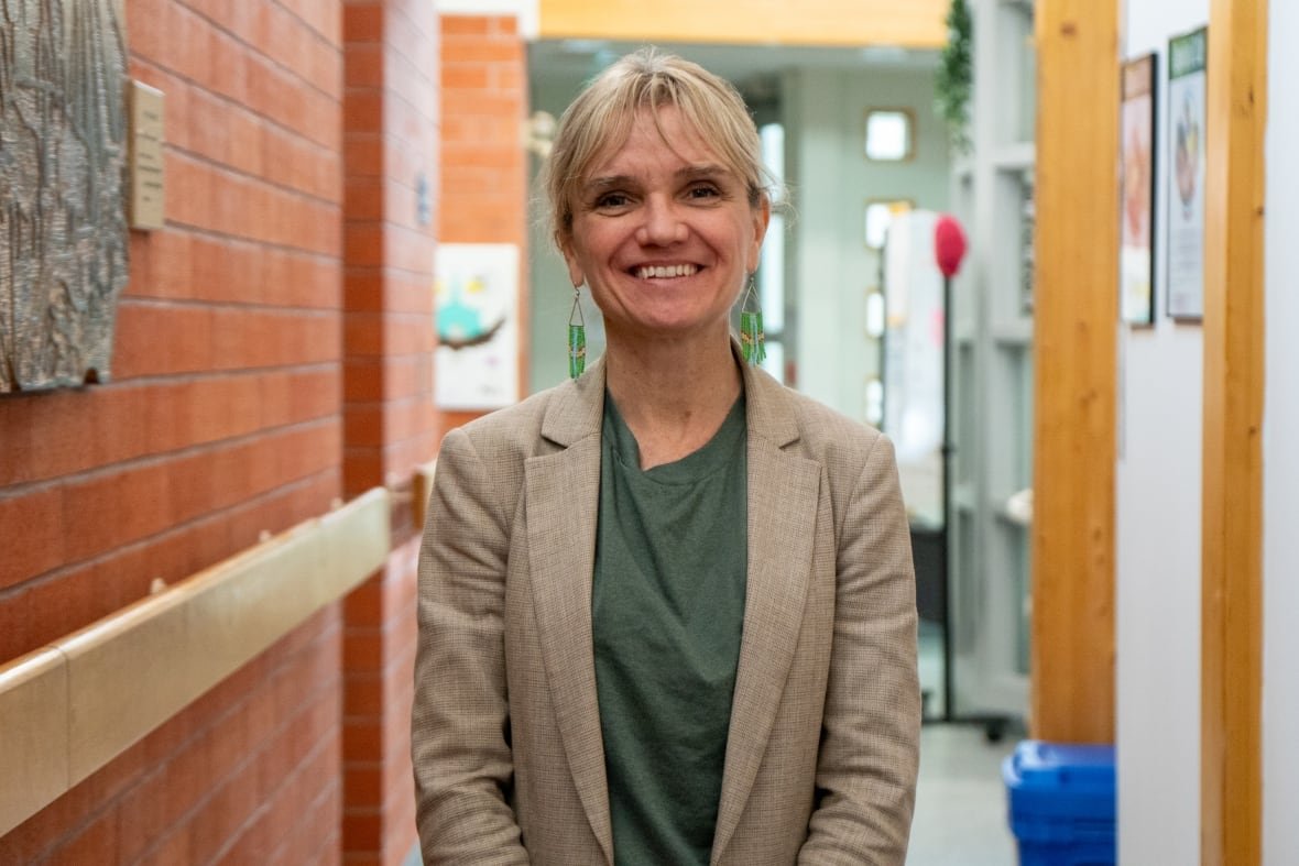 donna-jeanpierre A person is seen standing in a hallway, smiling.