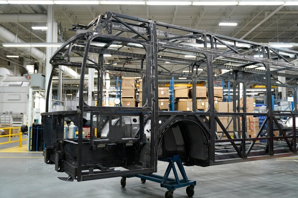 electric-vehicle-new-flyer The metal frame of a bus in a factory.