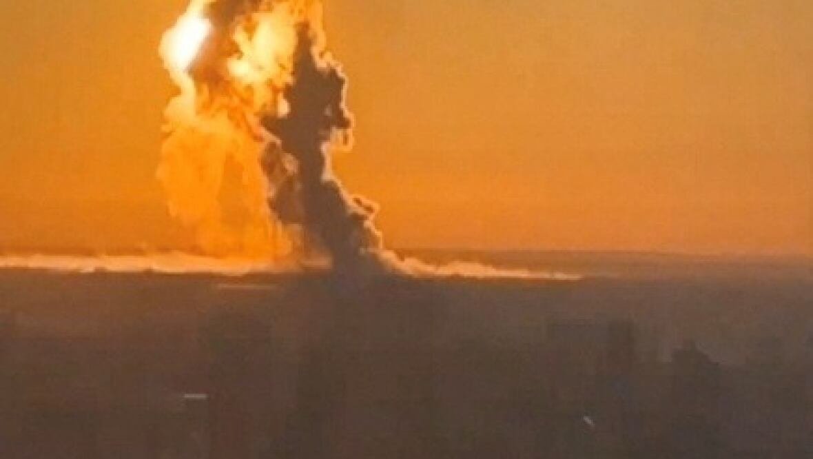 engeles A large ball of smoke is shown in the sky, lit up orange.