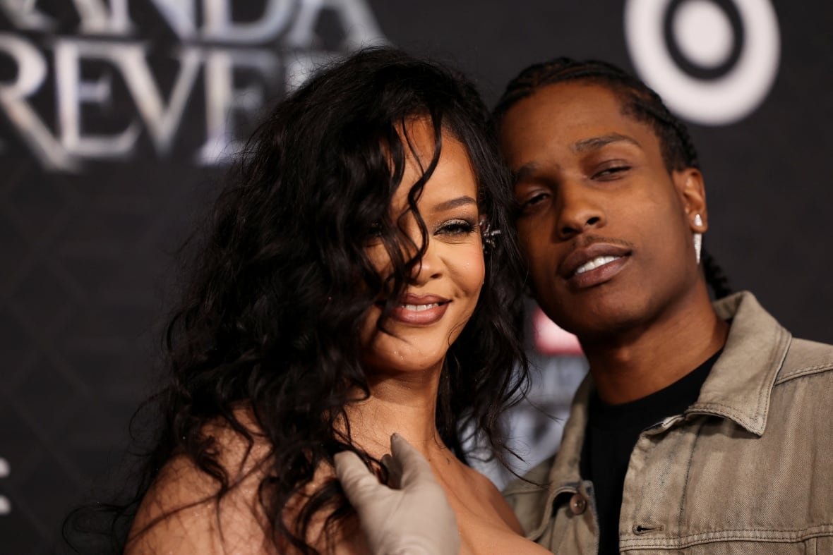 film-black-panther-wakanda-forever-premiere A couple are shown from the shoulders up, heads close together, smiling and posing.