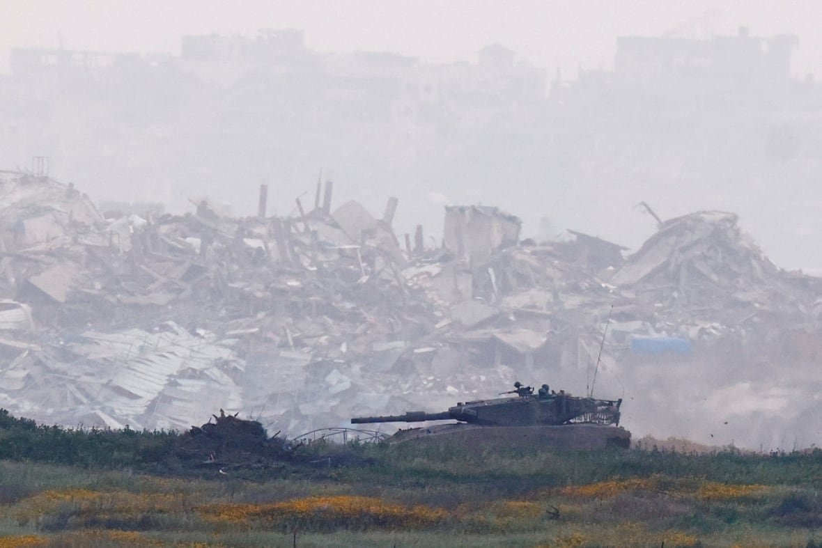 israel-palestinians-gaza-4 An Israeli tank manoeuvres inside Gaza, infront of destroyed buildings, as viewed from the Israel-Gaza border, March 20, 2025.